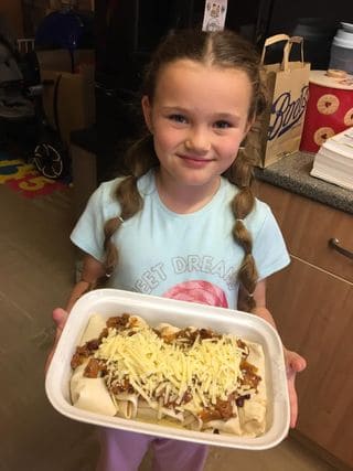Child with beef enchiladas