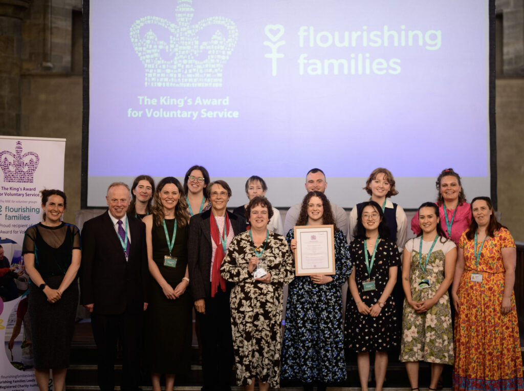 Staff team photo with Kins award and certificate